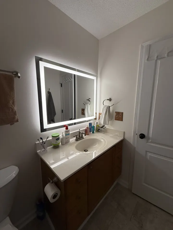 The same bathroom after paint and a new LED vanity mirror