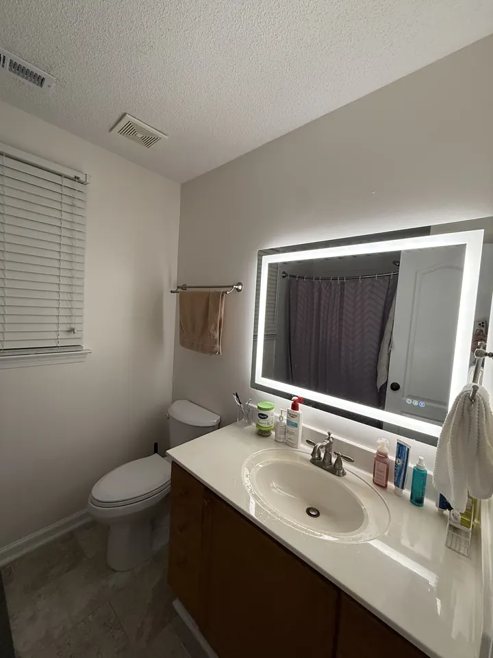 The refreshed bathroom from the doorway, LED mirror lit